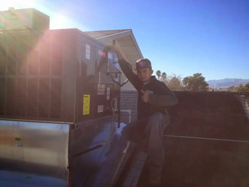 HVAC technician performing AC Tune-Up on a rooftop unit in Radnor